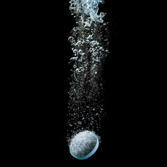 Realistic effervescent pill with fizzy bubbles in water. Soluble tablet dissolving with sparkling fizzy bubbles
