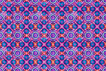 Colorful mandala seamless pattern with intricate floral designs in vibrant pink, blue, and purple tones, perfect for decorative and ornamental tile purposes