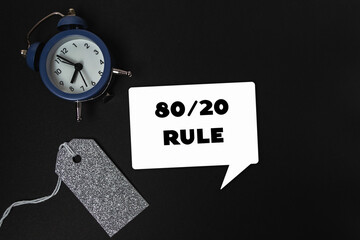 A blue clock sits on a black background with a tag that says 80/20 rule