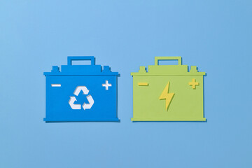 Handcraft paper cut car battery isolated on color background.