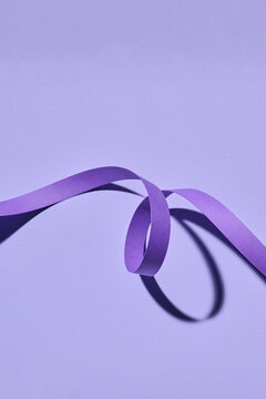 Spiral paper on a purple background. ribbon lines