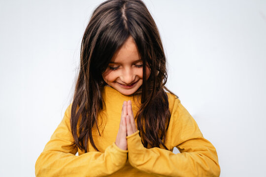 Happy Girl with Hands Together in Namast&eacute; Yoga greeting