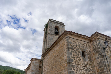 Fototapeta premium A large stone building with a bell tower. Church of Our Lady of the Assumption. Canales de la S
