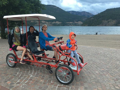 Family ride in a pedal car on vacation