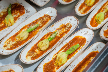 rows of empty plates with cut avocado sauce on them