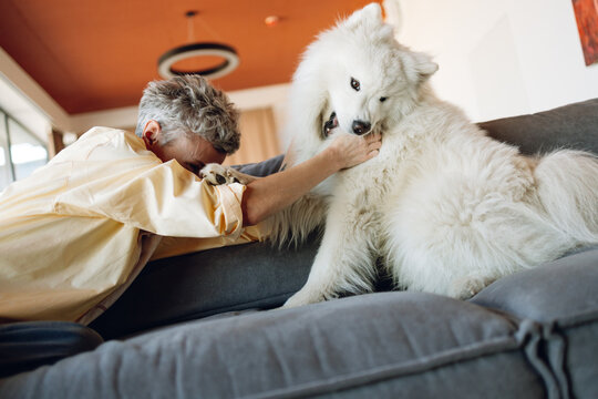 A woman with a dog indoors