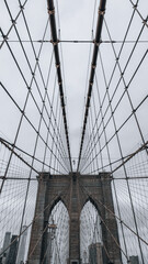 the view of brooklyn bridge from below on a rainy day