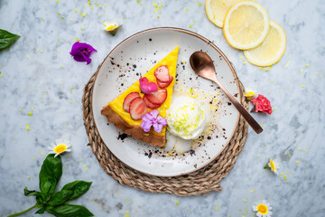 Top view of a plate with Vegan No-bake cheesecake topped with strawberry on the side cashew cream.