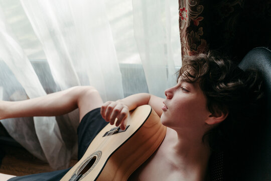 Young Musician Resting With Guitar