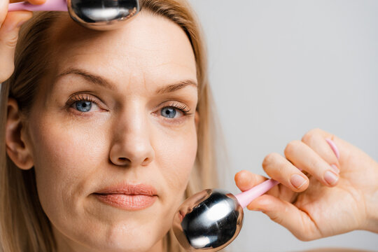 A woman does a facial massage