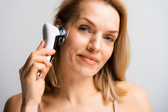 A woman does a facial massage