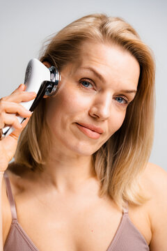 A woman does a facial massage