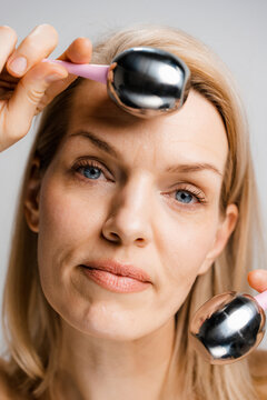 A woman does a facial massage