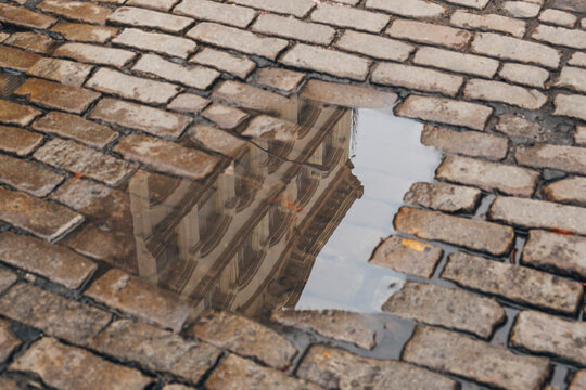 Building reflected in puddle. 