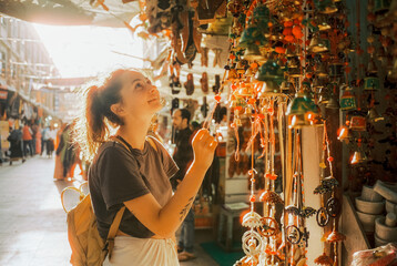 Woman buying souvenirs in India during her travels 