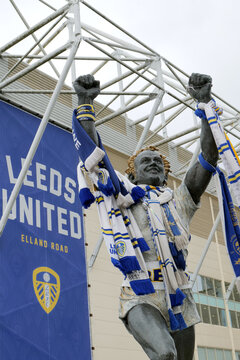 Statue of Leeds United player Billy Bremner draped in fans scarves celebrating outside their ground at Elland Road. Leeds, UK 05 23 2024