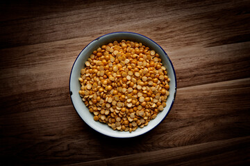 Bowl of dried lentils on a wooden surface