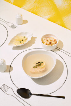 Creatively designed serving of restaurant fish broth.