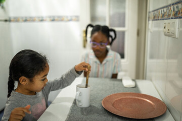 sisters having breakfast at home