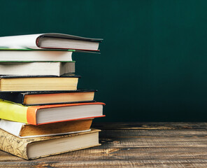 A stack of books on a wooden table