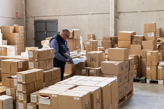 Warehouse supervisor checks inventory