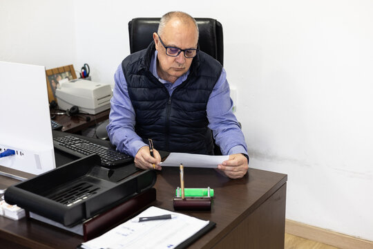 CEO checks a contract before signing it. 