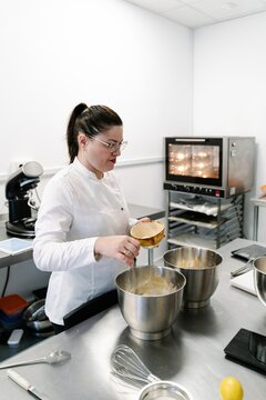 Professional pastry chef preparing cake batter in kitchen