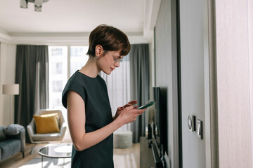Woman adjusts Smart Home Panel