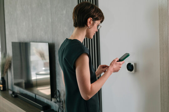 Woman adjusts Smart Home Panel