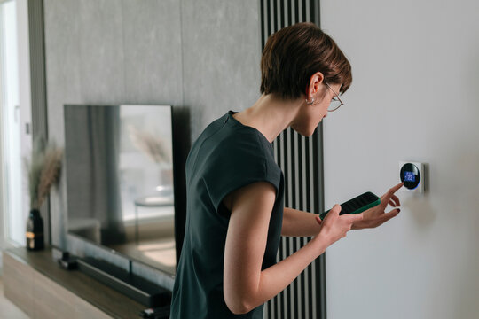 Woman adjusts Smart Home Panel