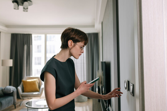 Woman adjusts Smart Home Panel