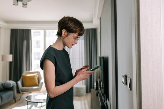 Woman adjusts Smart Home Panel