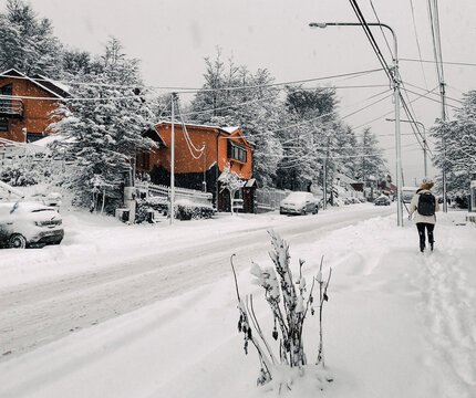 Woman walking in the snowy city 