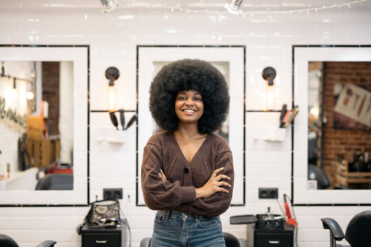 hairdresser talking to client after cutting and styling afro hair