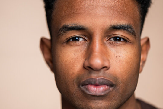 Close-up portrait of a young man with neutral expression