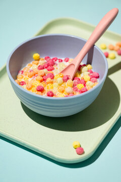 Colorful ball-shaped pop breakfast cereal on blue background