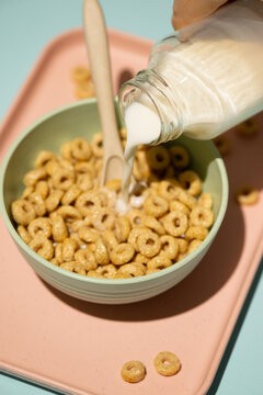 Pouring nut milk over breakfast cereal
