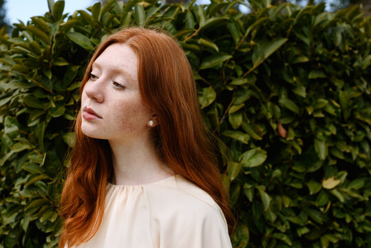 Portrait of redhead 15 years-old girl with freckles