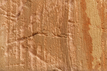 Close-Up of Weathered Stone Surface With Natural Texture and Orange Hue Striations