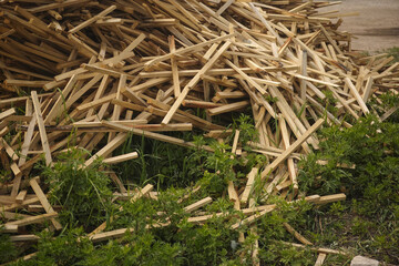 A pile of lumber lying on grass. Close up.