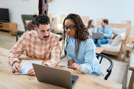 Young Professionals Collaborate In A Modern Office.