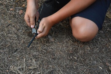 A child playing with a fire-burning flint