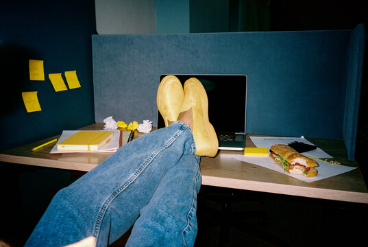 Office lunch, feet up in yellow shoes on desk