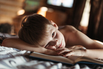 Resting Young Boy Reading in Soft Indoor Light