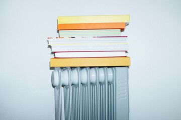 Extra radiator and book stack in business office with hard flashlight