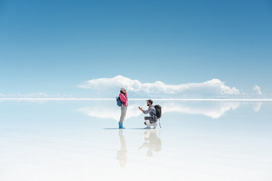 Man Proposing Marriage To Girlfriend in beautiful natural landscape
