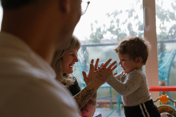 Child and parents playing together indoors