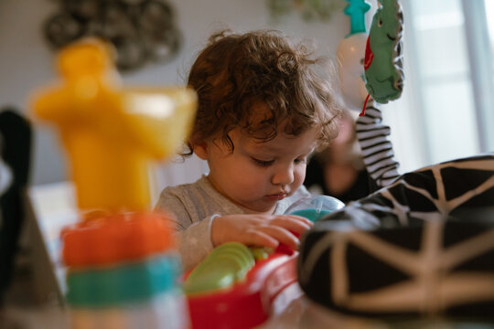 Child focused on playing with toys