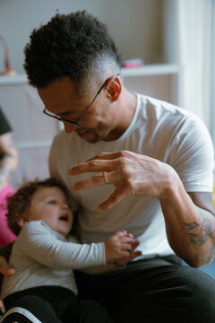 Man holding hands with child teaching