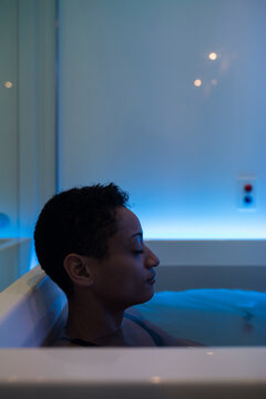Side view of a person in a sensory deprivation float tank